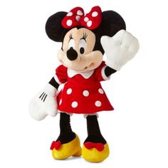 a minnie mouse stuffed animal with a red dress and polka dots on it's head