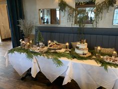 the table is set up with many different foods and desserts on top of it