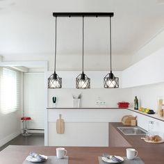 the kitchen is clean and ready to be used for breakfast or dinnertime, with modern lighting fixtures