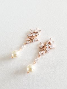 "Gorgeous sparkly cubic zirconia wedding earrings for the bride. Handcrafted with Swarovski pearls and high quality cubic zirconias. For pierced ears only. I do have other types of pearls available such as freshwater pearls and shell pearls that are in different shapes & sizes. Please contact for other options. ♥ SIZE: 2 1/8\" long x 3/4\" wide ♥ COLORS: Silver, Gold, Rose Gold ♥ PRODUCTION TIME: Ready to ship out in 1-2 business days ♥ IMPORTANT: Please be sure to read my policy section for Rose Gold Cubic Zirconia Dangle Pearl Earrings, Pearl White Cubic Zirconia Earrings For Wedding, Pearl White Bridal Earrings With Pearl Drop, Delicate Dangle Cubic Zirconia Pearl Earrings, Pearl Embellished Cubic Zirconia Wedding Earrings, Wedding Pearl Earrings With Sparkling Cubic Zirconia, Wedding Crystal Earrings With Pearl Drop, Delicate Dangle Pearl Earrings With Cubic Zirconia, Wedding Pearl Drop Crystal Earrings In Cubic Zirconia