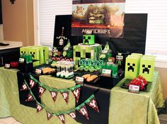 a minecraft themed party with green and red decorations on the table, including cake