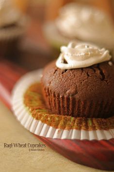 a chocolate cupcake with whipped cream on top