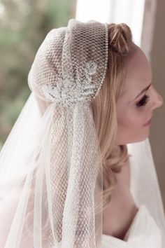 a woman wearing a veil with flowers on it