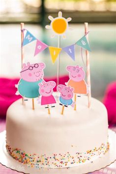 a birthday cake decorated with pepo and friends on the top is sitting on a table