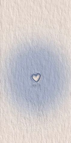 a heart shaped hole in the middle of a white wall with blue paint on it