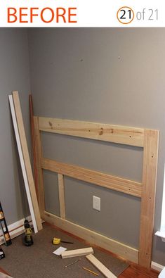 a bed frame is being built in the corner of a room with tools on the floor