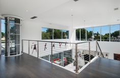 an open floor plan with glass balconies and steel handrails is shown