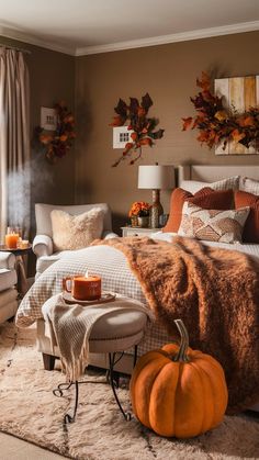 a bedroom decorated in fall colors with pumpkins on the bed and other decor items