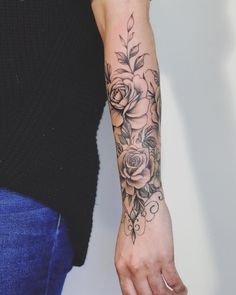 a woman's arm with a flower tattoo on the left side of her arm