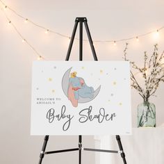 a welcome sign for a baby shower with an elephant on the moon and stars in the sky