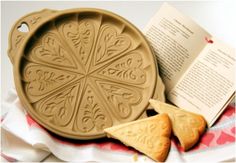 an open book and some cookies on a table