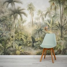 a green chair sitting on top of a wooden table in front of a wall mural