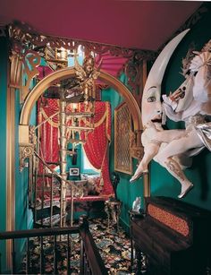 an elaborately decorated room with a statue on the wall and a bed in the corner