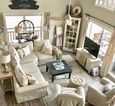 a living room filled with furniture and lots of windows