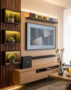 a living room with a large flat screen tv mounted on the side of a wall