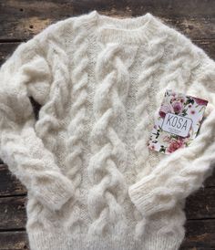 "White cable knit fluffy women pullover wiht round neck. Product Details: * 100% hand knit * 75% alpaca, 25% merino wool. Regular fit. Size: S(4-6) M(8-10) L(12-14) S Width : 46/48 cm Length: 58/60 cm M Width : 50/52 cm Length: 60 cm L Width : 54 cm Length: 62 cm Please let me know your size. It is made for order. If you would like me in other size, you could request a custom order with your own parameters: your height, bust and length of the sweater from the shoulder in cm. Or add your comments Hand Knitted Mohair Cream Sweater, Hand Knitted Cream Mohair Sweater, Cream Mohair Hand-knitted Sweater, White Knitted Alpaca Sweater, White Hand Knitted Alpaca Sweater, Cozy Mohair Sweater With Cable Knit, Cozy Mohair Cable Knit Sweater, Cream Knitted Alpaca Sweater, Cream Long Sleeve Alpaca Sweater