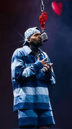 a man in blue and white striped shirt holding a microphone