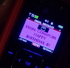 a cell phone with a happy birthday message displayed on it's display screen in the dark