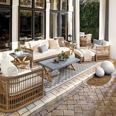 an outdoor living room with wicker furniture