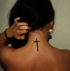 a woman with a cross tattoo on her back