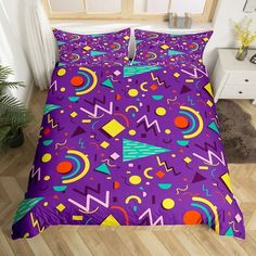 a bed covered in purple and orange sheets