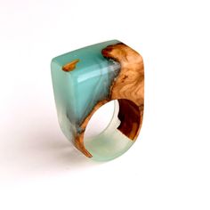 Embrace the natural beauty of our olive wood epoxy ring, a fusion of rich olive wood patterns and soothing milky turquoise epoxy. Crafted with meticulous attention to detail and protected with premium tung oil infused with citrus solvent, this ring offers both durability and style. Sized approximately at 16.9, it ensures a comfortable fit for daily wear. However, it's important to note that it's not recommended for water wear. Elevate your accessory collection with our olive wood epoxy ring, a t Epoxy Ring, Ring Resin, Wood Epoxy, Ring Turquoise, Wood Ring, Wooden Ring, Resin Ring, Wood Rings, Turquoise Rings