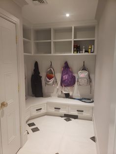 the inside of a white closet with black and white checkered flooring