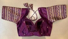 Beautiful purple choli-cut saree blouse with golden embroidery. Buy designer blouse in USA from Pure Elegance. Disclaimer: The actual product may vary slightly from the image. These are custom orders, hence expect slight variation in color, placement of the motif or buta. ESTIMATED DELIVERYBecause this is a custom order, it would take about 4 weeks from the date of purchase. RETURN POLICY: This product is a custom order and cannot be returned or exchanged. Purple Choli, Designer Saree Blouse, Saree Blouses Online, Golden Embroidery, Indian Clothing Store, Blouse Designer, Corset Blouse, Saree Style, Readymade Saree