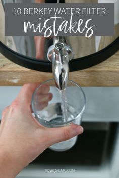 a person holding a glass in front of a mirror with the words 10 berky water filter