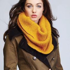 a woman wearing a yellow knitted scarf