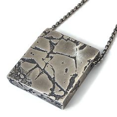 "This geometric pendant that has a unique rustic look is the perfect necklace for the trendsetting man.  It would also make a great gift for your rugged husband.  Show off your funky style when you wear this unique necklace!  For a mixed metal version of this pendant click here  👉 https://www.etsy.com/listing/746990503/ 🔶 Materials ▫️ Oxidized sterling silver  🔶 Dimensions ▫️ Hight: 1.5\" (3.8 cm) ▫️ Width: 1.4\" (3.5 cm) ▫️ Depth: 0.3\" (0.75 cm)  ▫️ Chain length: 23\" (58 cm) 🔶 Weight ▫️ Doesn't this piece look heavy? I know it does. But it isn't! So how do I achieve this?  My chunky pieces are all hollow form. So they look like they are a solid piece of metal, but they are actually empty inside. This way you don't have to be a weight lifter to wear them!  ▫️ After a lot of testing, Primitive Jewelry, Second Anniversary Gift, Hollow Form, Urban Jewelry, Funky Style, Modern Jewellery Design, Cube Necklace, Vertical Bar Necklace, Silver Necklace Statement