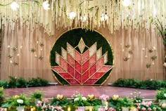 a stage with flowers and greenery on it