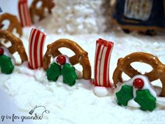 some pretzels and candy canes are on top of the snow covered ground