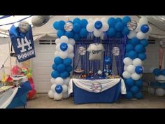 a baseball themed birthday party with balloons and decorations on the table, including a dodgers jersey