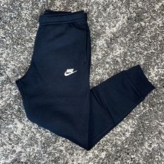 New Nike Sportswear Standard Fit Tapered Leg Club Fleece Joggers Color: Black/Black/White Size: Small Mens *Please Feel Free To Ask Any Questions!!! *Ships Same Day Or Next!!! Classic Comfort. A Closet Staple, The Nike Sportswear Club Fleece Joggers Combine A Classic Look With The Soft Comfort Of Fleece For An Elevated, Everyday Look That You Can Wear Every Day. Soft Comfort Brushed-Back Fleece Fabric Feels Soft And Smooth. Joggers Style Ribbed Cuffs Give You That Classic Joggers Look And Show O Nike Joggers Mens, Blue Tracksuit, Mens Lounge Pants, Nike Sportswear Club Fleece, Easy Cash, Athletic Clothes, Iphone Obsession, Mens Tights, Nike Joggers