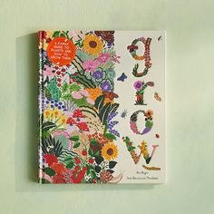 a book with flowers and letters on it