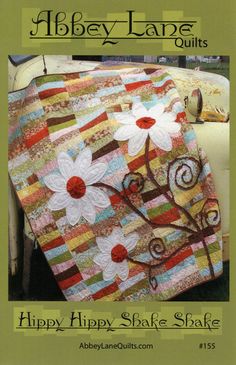 a quilted cover with flowers on it and the words happy hippy state shaker