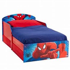 a child's bed with a spiderman theme