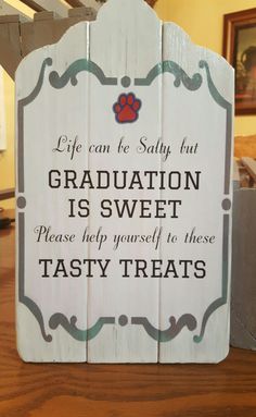 a wooden sign that says, life can be salty but graduation is sweet please help yourself to those tasty treats