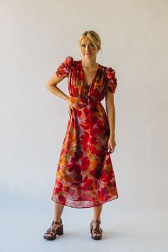 The Fannon Floral Midi Dress in Red Multi is sure to turn heads with its vibrant colors and playful floral pattern. With a comfortable and flattering midi length, this dress is perfect for any occasion. Bring a touch of whimsy to your wardrobe with this one-of-a-kind dress. Details self/lining: 100% polyester Fabric Care Guide Here Sizing & Fit Measurements are approximate and taken while laying flat across the front. Not doubled. small: bust = 18"; length = 48" medium: bust = 19"; length = 48.5 Puff Sleeve Sweater, Striped Sweater Dress, Striped Knit Dress, Floral Midi Dress, Cardigan Jacket, Striped Knit, Small Bust, Stripe Sweater, Dress Details