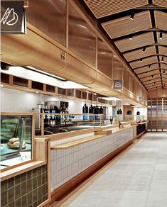 the inside of a restaurant with wooden ceilings and tile flooring, along with an open buffet area