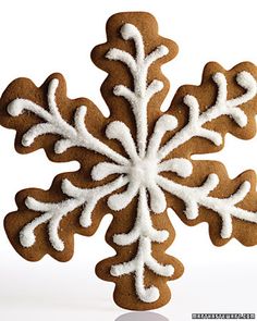 a snowflake shaped cookie with white frosting