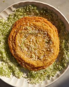 some food is on a white plate and it looks like they are covered in green stuff