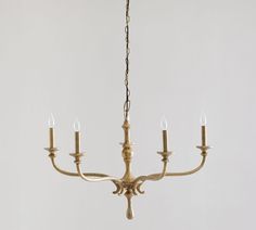 a chandelier with five candles hanging from it