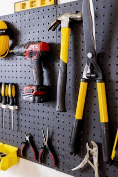 there are many tools hanging on the pegboard