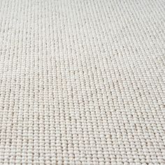 close up view of the texture of a white carpet