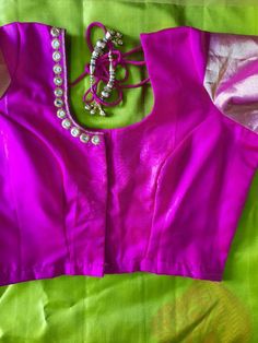 Pink kanchipuram silk blouse. Beautifully emb at the neck line. Princess cut front open with hook and eye. It can be customized to any size. Pl leave a msg for customization. For customization i will send you the measurement chart which you can fill and send it back to me . If you want to go by the standard measurement choose the size from the option below based on the size chart in the last pic it will be stitched. Designer Wear Padded Blouse Piece For Diwali, Padded Blouse Piece For Navratri Designer Wear, Designer Padded Blouse For Navratri, Elegant Pink Blouse For Puja, Festive Padded Blouse Piece For Puja, Traditional Drape Blouse With Mirror Work For Puja, Traditional Festival Blouse Piece With Padded Detail, Designer Silk Choli With Padded Blouse, Silk Pink Blouse With Mirror Work