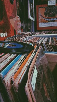 a record player sitting on top of a pile of records