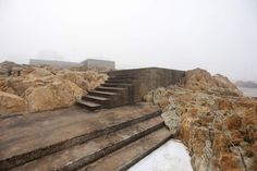 there are many steps leading up to the beach on this foggy day with no one in sight