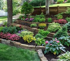 a garden with flowers and trees in the background